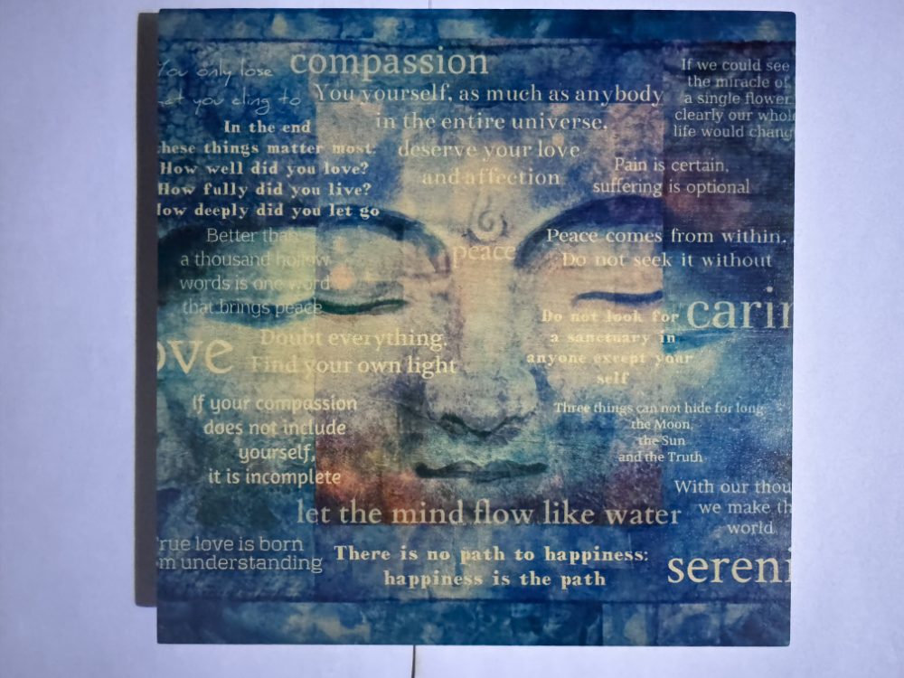 Mixed-media artwork of a serene face layered with words on compassion, peace and understanding